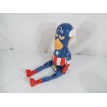 A good quality carved wooden shelf puppet depicting Captain America.