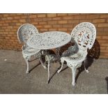 A good quality wrought iron garden table and two matching chairs,