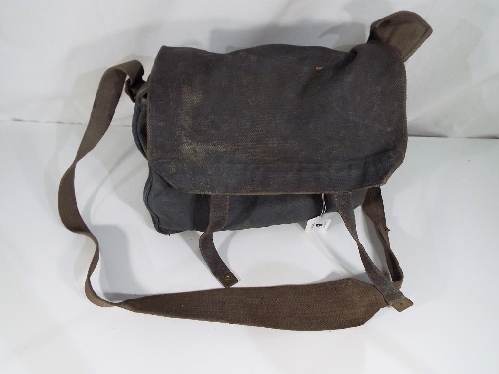 A military satchel bearing the crow's foot / arrow mark in blue,