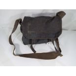 A military satchel bearing the crow's foot / arrow mark in blue,