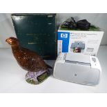 An HP Photosmart A314 compact photo printer / camera bundle and a Royal Doulton decanter in the