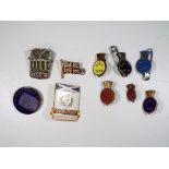 A collection of vintage enamel lapel badges and pin badges