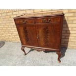 A two drawer over two door wooden cabinet,
