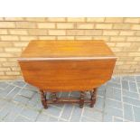 A good quality oak gate-leg drop-leaf table on barley twist supports,