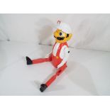 A good quality carved wooden hand-painted shelf puppet depicting Mario.