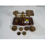 A set of postal scales and weights.