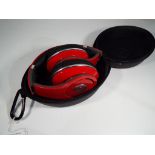 Beats by Dr. Dre - a pair of headphones in soft case.