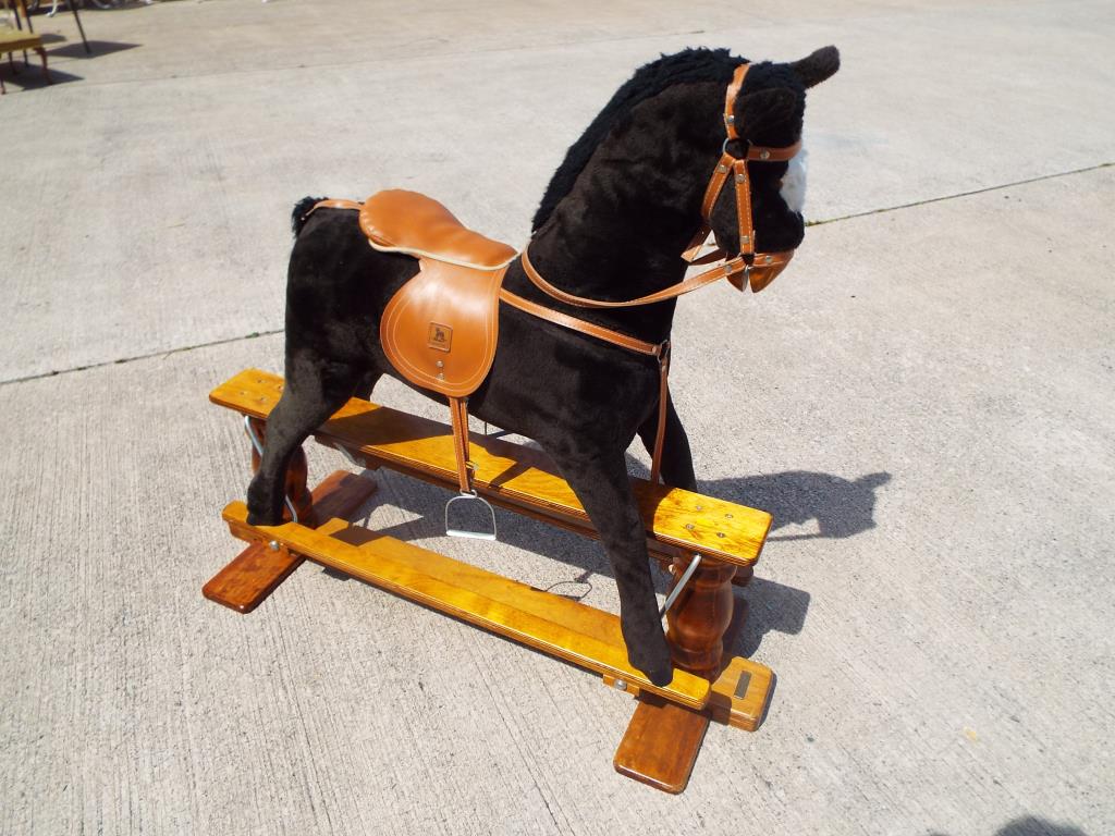 A good quality Mamas and Papas child's rocking horse on wooden base,