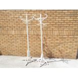 Two wooden coat stands in neutral colours
