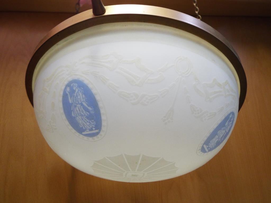 An antique opaque glass light shade on three chains.