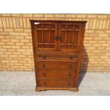 An oak carved cabinet two door over four drawers approximate height 123 cm (h) x 77 cm x 47 cm