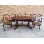A good quality extending dining table with four chairs and two carvers,