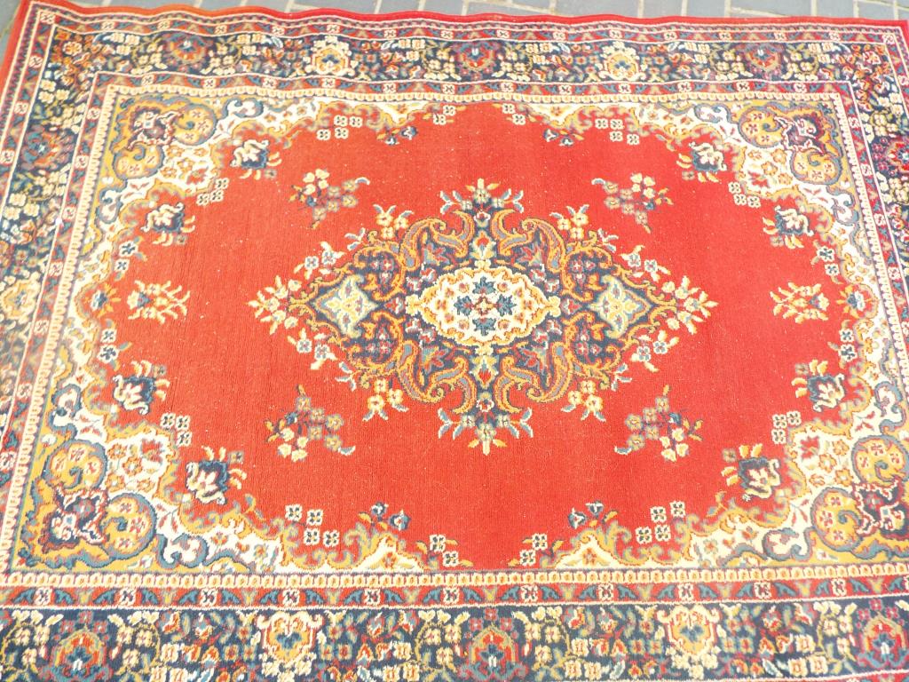 A Mona Lisa rug on a dark red ground in a traditional style,