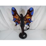 A good quality table lamp in the form of a lady with butterfly wings in a Tiffany style.