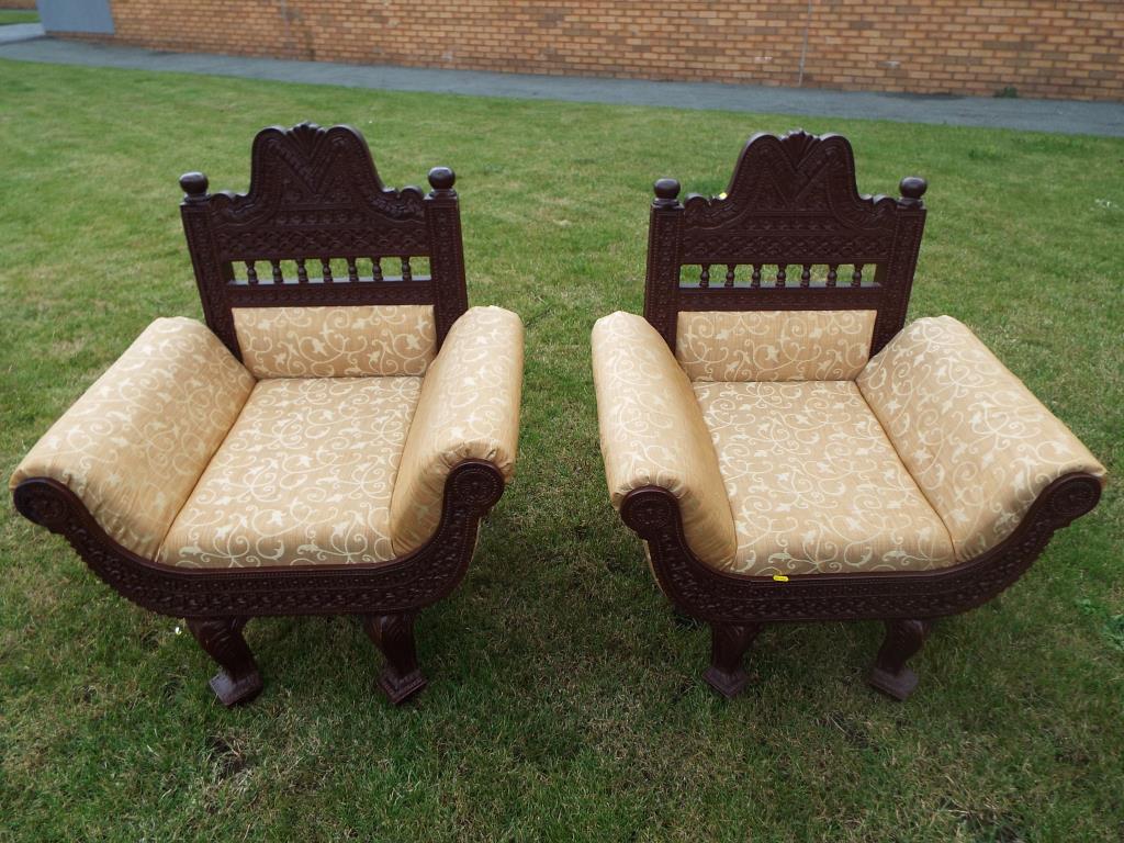 A matched pair of Indian carved teakwood armchairs with upholstery - [2] - Image 3 of 3