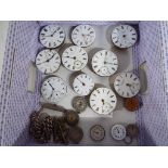 A quantity of antique pocket watch faces.