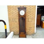 A 1920's long case clock with pendulum and three weights,