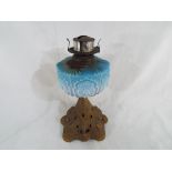 A Victorian opaque blue glass oil lamp on a pierced metal base Est £30 - £50