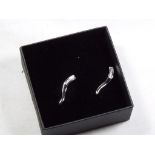 A lady's pair of 9 carat white gold 10 pt diamond set stick earrings, approx weight 1.