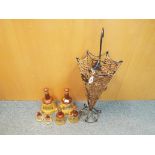An unusual umbrella stand and 6 empty Bells scotch whisky decanters (qty)
