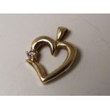 A heart shaped 9 carat gold pendant with round brilliant cut diamond, approximate weight 1.