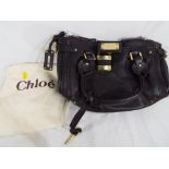 Clothing - a designer leather handbag by Chloe (brown) with material dust cover