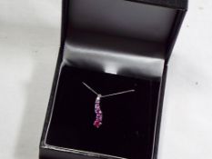 A 9 carat white gold pink sapphire drop pendant, approx weight 1.