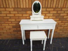 A modern dressing-table with stool and mirror