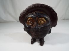 A cast iron novelty money bank marked 'Save and Smile Money Box', 10.
