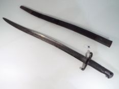A French model 1842 yataghan sword bayonet with leather grip and leather scabbard with metal mounts