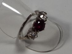 A lady's ruby and diamond three stone presumed 18ct white gold, approx diamond weight 0.