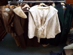 Four lady's coats, one light brown fur coat marked Leeds Boston, approximate length 60 cm ,
