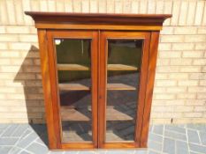 A good quality mahogany display cabinet / bookcase with glazed twin doors and shelved interior,