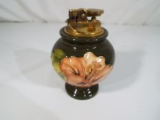 Moorcroft Pottery - a cigarette lighter decorated with pink coral hibiscus on a green ground, 11.