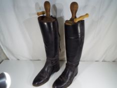 A pair of gentleman's riding boots in boot stretchers