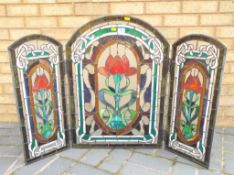 A three panel stained glass screen approximately 71 cm x 104 cm