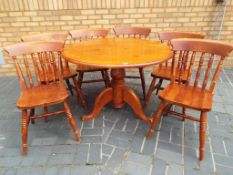 A good quality round pine dining table with six matching chairs approximate height 74 cm x 103 cm