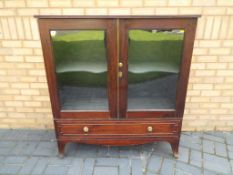 A glass fronted display cabinet over one drawer approximate height 126 cm x 115 cm x 42 cm