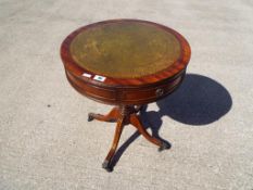 A good quality leather topped drum table,
