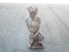 Garden ornament - a stoneware statue depicting a Pan in a seating position approx height 72 cm