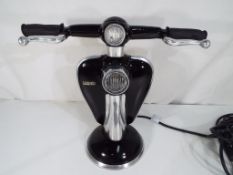 A good quality lamp in the form of a Lambretta scooter.