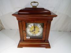 A 17th century style American stained beechwood bracket clock, the dial marked Howard Miller,