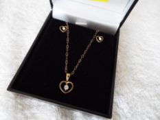 A lady's 9 carat gold cubic zirconia earring and pendant set, approx weight 2.
