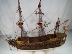 A scratch built model of a three masted galleon 52cm (h) x 60cm (l)