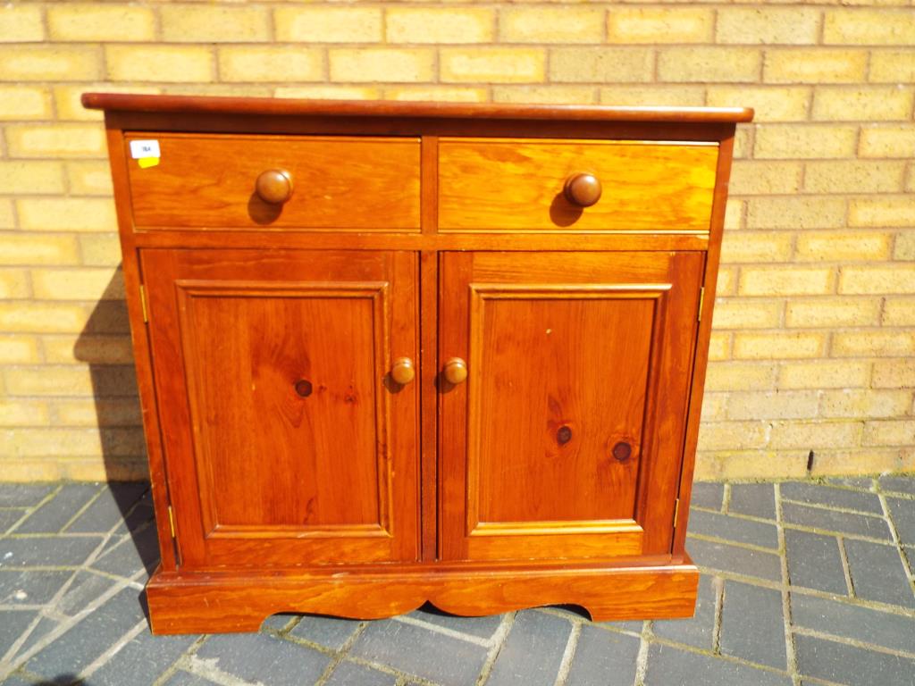 A good quality pine cupboard with two drawers,