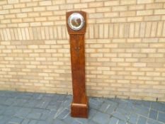 A walnut cased granddaughter clock, Westminster chimes, with pendulum,