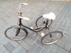 A child's vintage black tricycle marked 'Sunbeam',