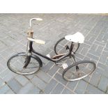 A child's vintage black tricycle marked 'Sunbeam',