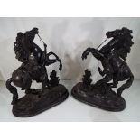 A pair of black painted spelter Marley horse groups on wooden stands,