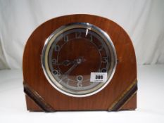 A mahogany cased art deco mantle clock Arabic numerals,